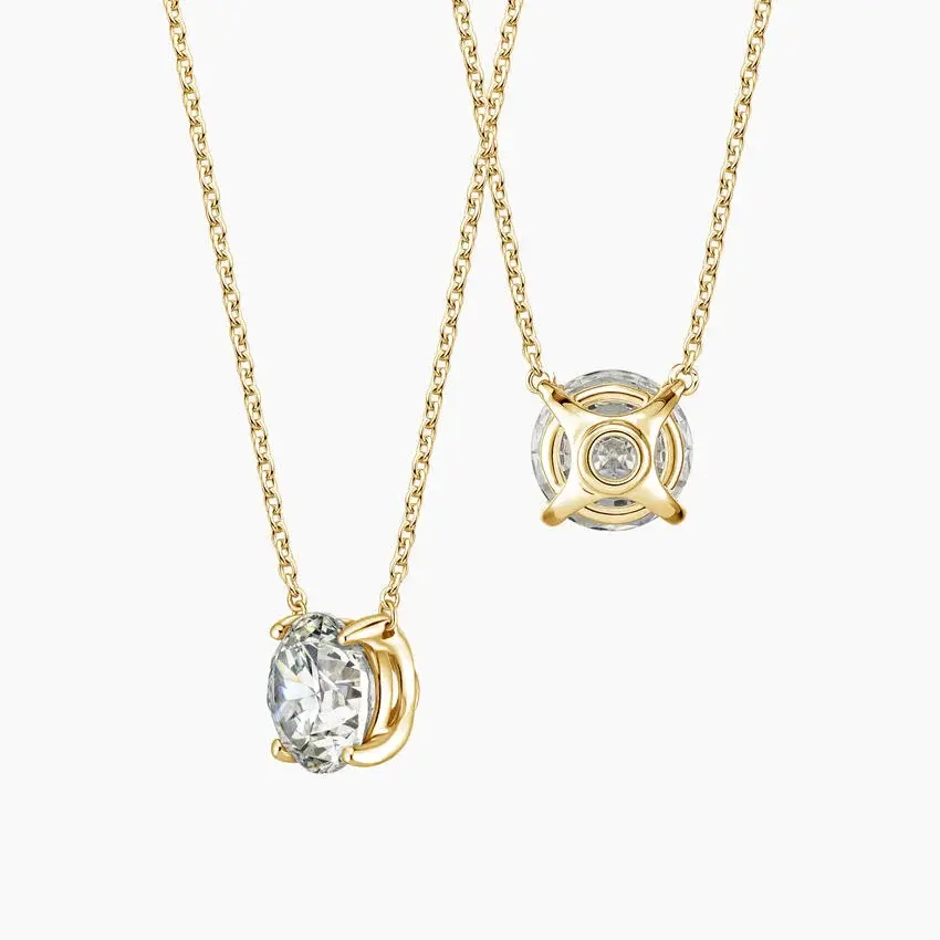 Elegant gold necklace with dazzling oval and round diamond pendants.