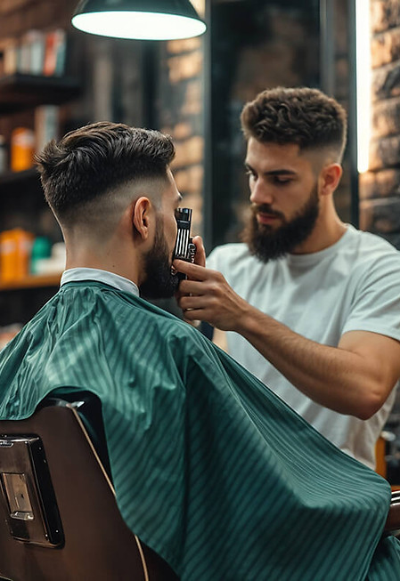 Barber trimming a man's beard in a barbershop.