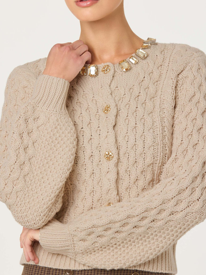 Beige cable knit cardigan with jewel-embellished neckline