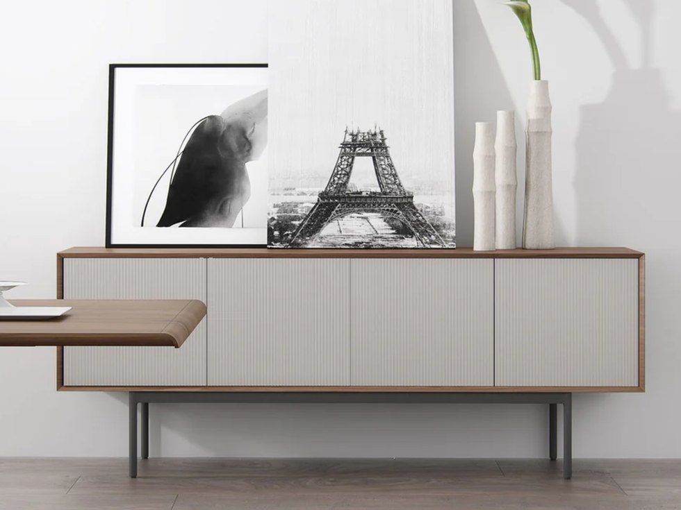 Modern sideboard with artwork and decor; image of Eiffel Tower and art.