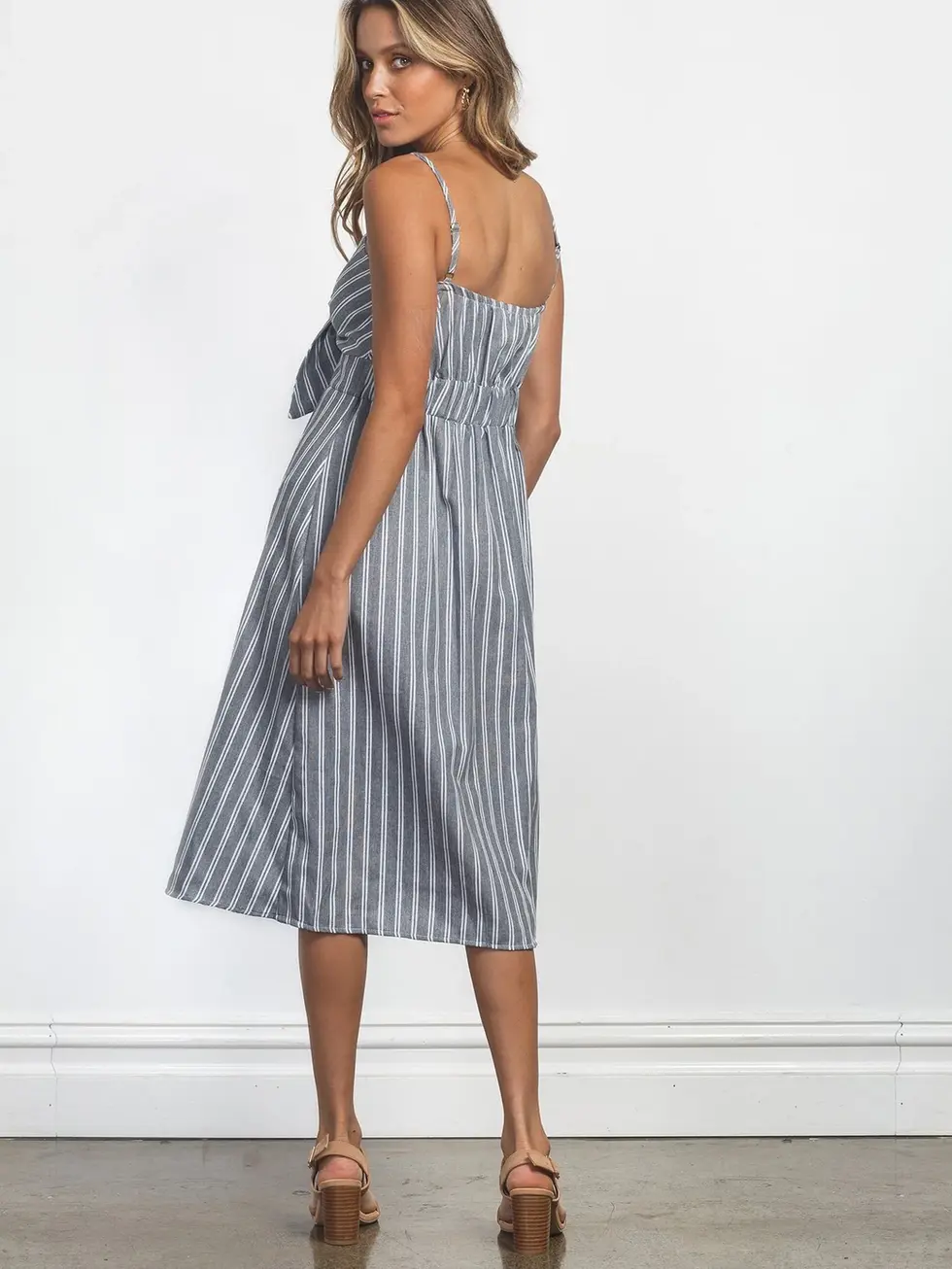 Woman wearing striped dress, turning back. The Charme with Carter Playsuit.