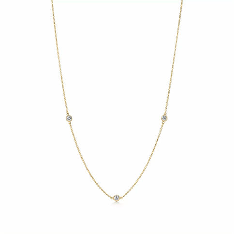 Delicate gold necklace with three small gemstones