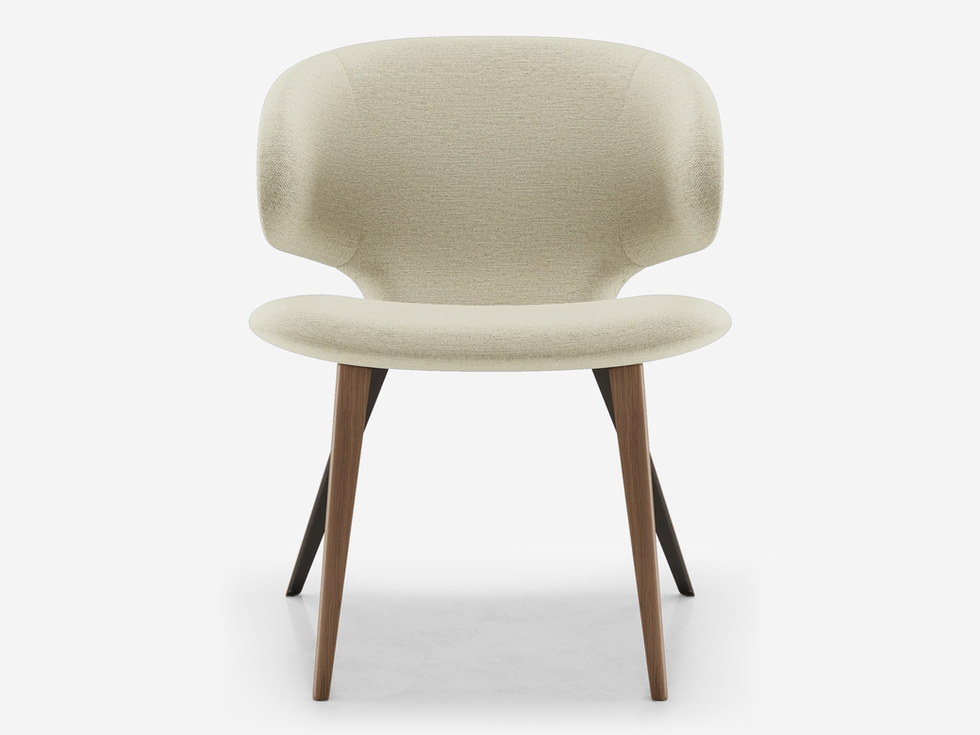 Cream-colored modern chair with wooden legs against a white background.