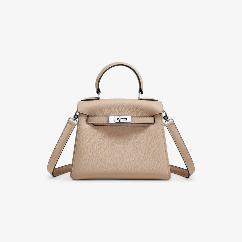 Beige handbag with silver hardware and top handle, elegant, chic, modern style.