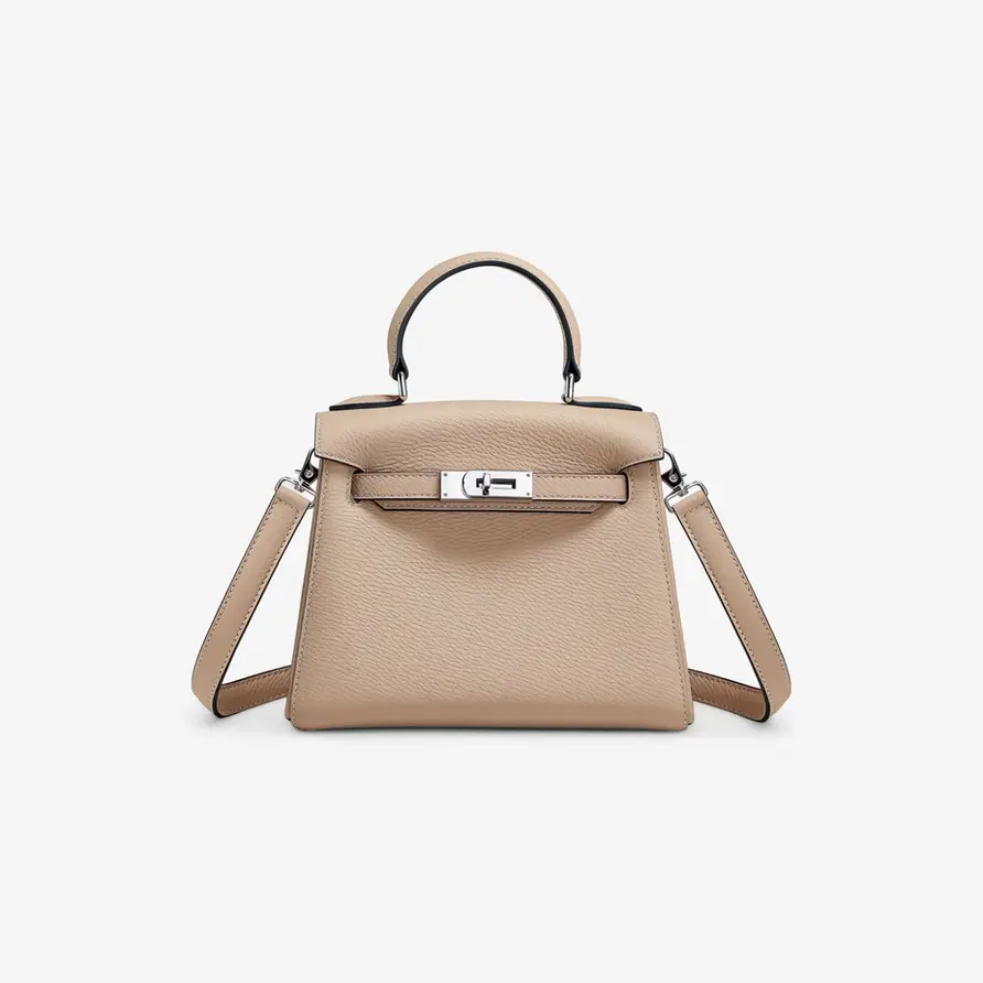 Beige handbag with silver hardware and top handle, elegant, chic, modern style.