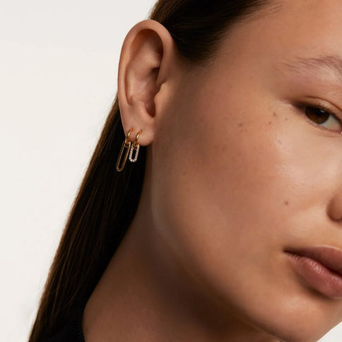 Woman wearing gold linked earrings