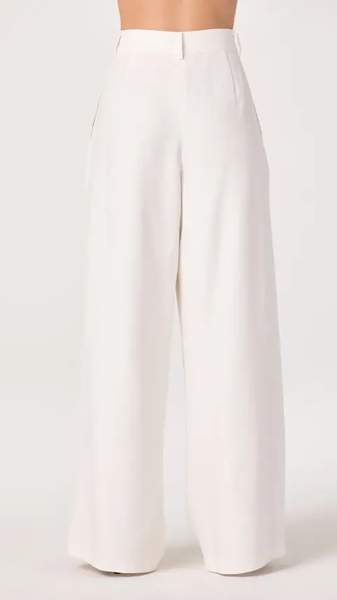 White wide-leg trousers paired with a tailored blazer.