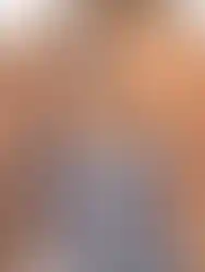 Woman's back wearing a white dress with blue and pink patterns.