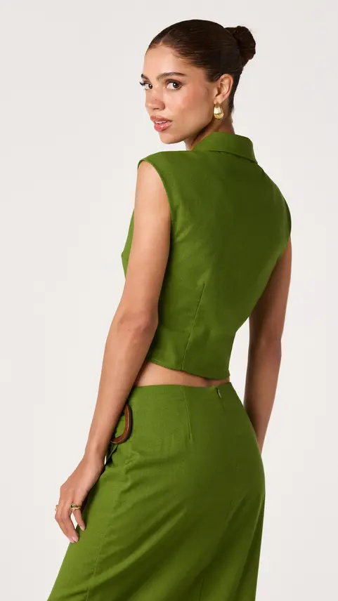 Back view of a woman in a sleeveless olive green vest
