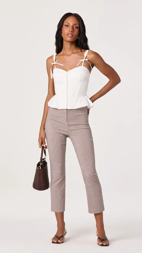 Woman wearing white peplum top and Kristen Pointelle pants
