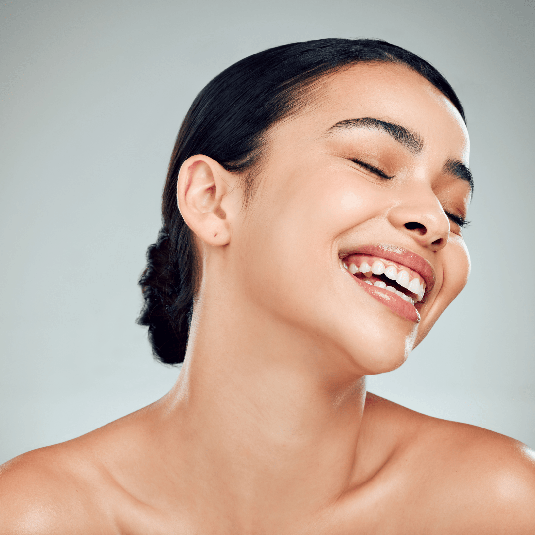 Woman laughing joyfully, radiant skin