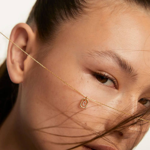 Woman wearing delicate gold Sand Solitary Necklace