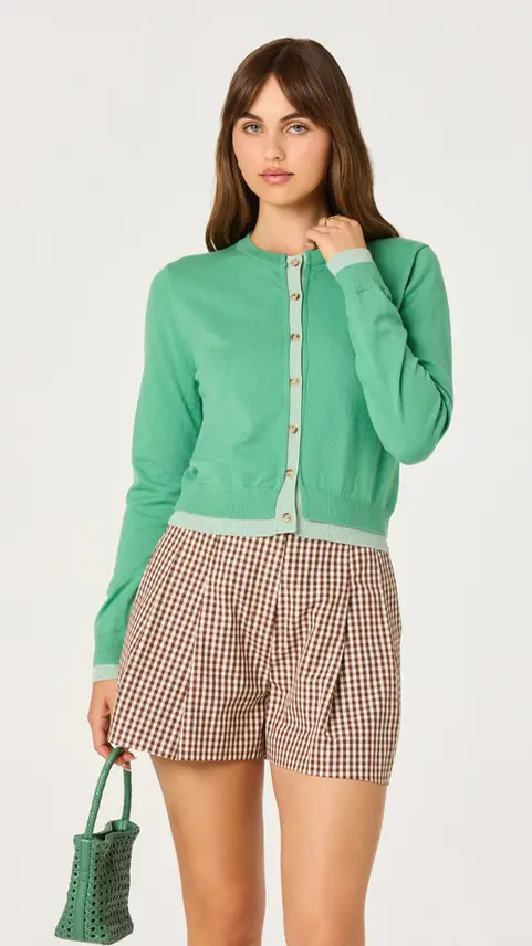 Woman wearing the Kristen Pointelle Collar Cardigan in green.