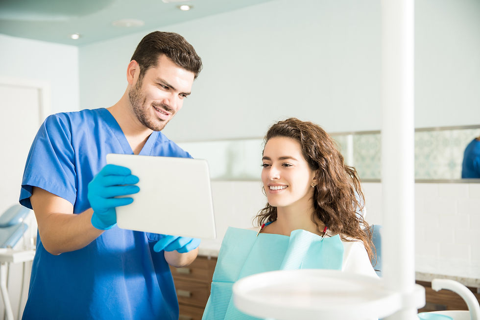 Dentist showing patient X-rays on tablet