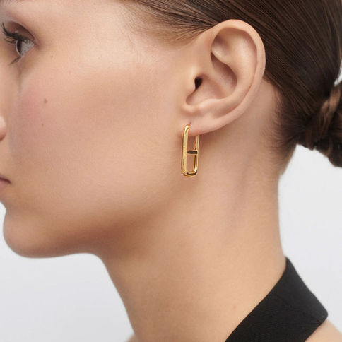 Gold rectangle earrings on model