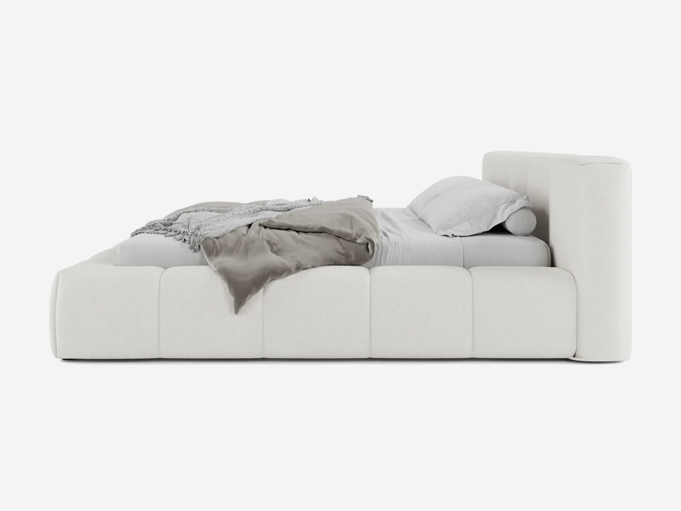 White bed with pillows and a blanket; Halsted Bed on white background.