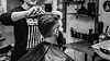 Barber cutting a man's hair in a barbershop