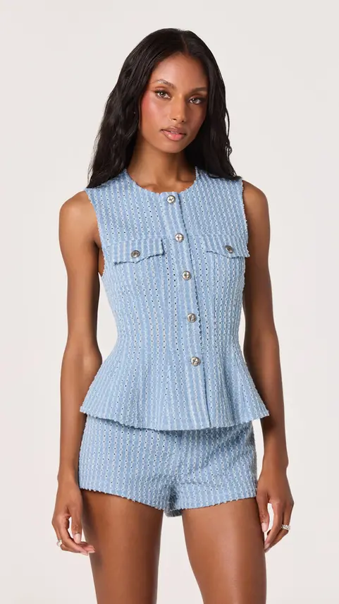 Woman wearing a light blue Kristen Pointelle peplum vest