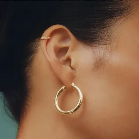 Woman wearing gold hoop earrings