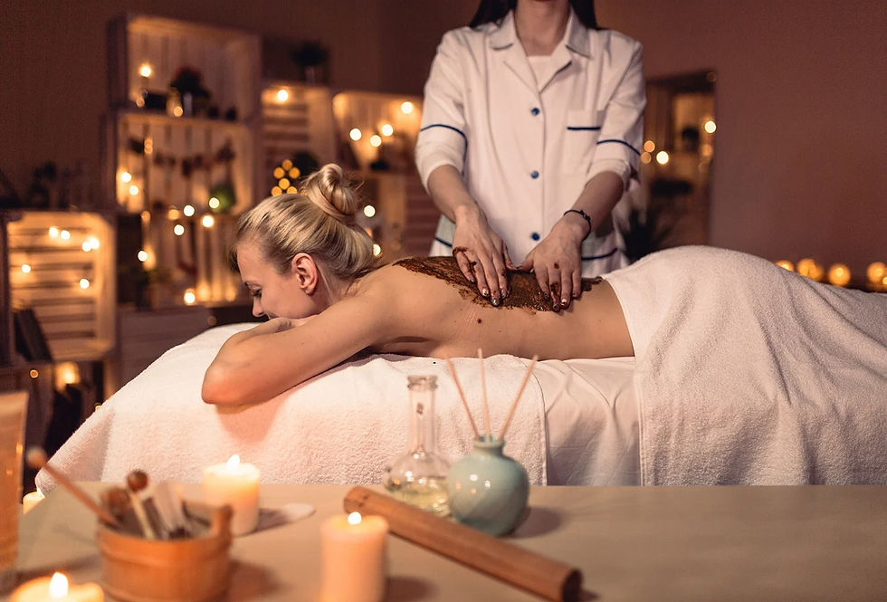 Woman receiving a relaxing back massage in a candlelit spa