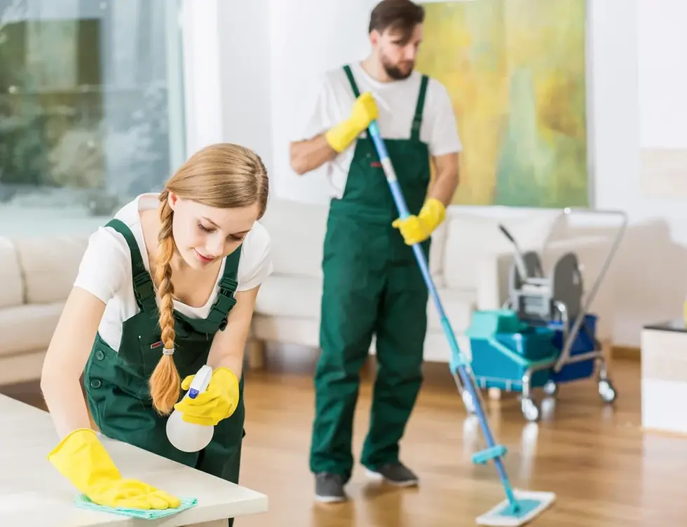 Two professional cleaners wiping a table and mopping a floor