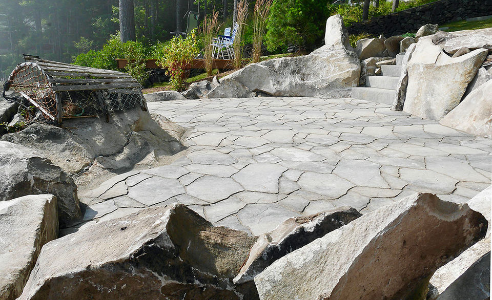 Rugged patio with rocks and lobster trap