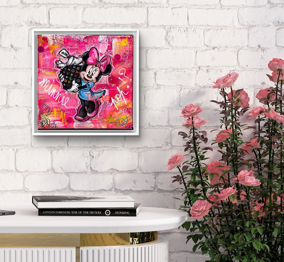 Pop Colorful Minnie Mouse artwork on a pink background with text, framed on a white brick wall. Pink roses and a table with books below.
