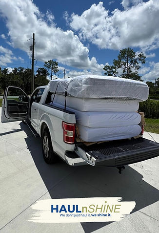 White pickup truck loaded after a junk removal job for a hotel in Lakeland