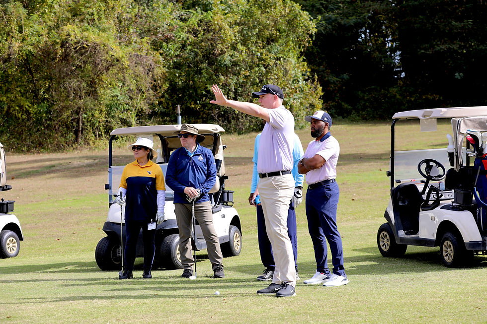 PGA Professional Patrick Feindt instructs Links to Freedom participants and volunteers during an adaptive golf session before the day's lesson begins.