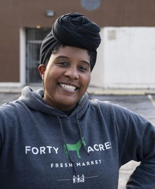 woman with head wrap smiling