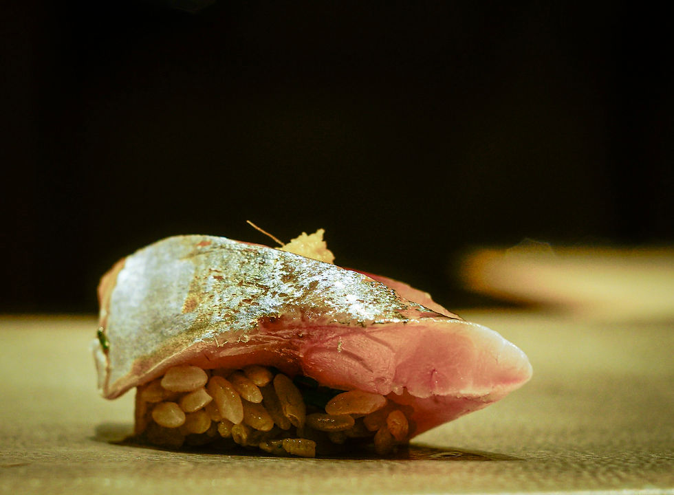 Eye-level view of a seasonal omakase platter with autumn leaves decoration