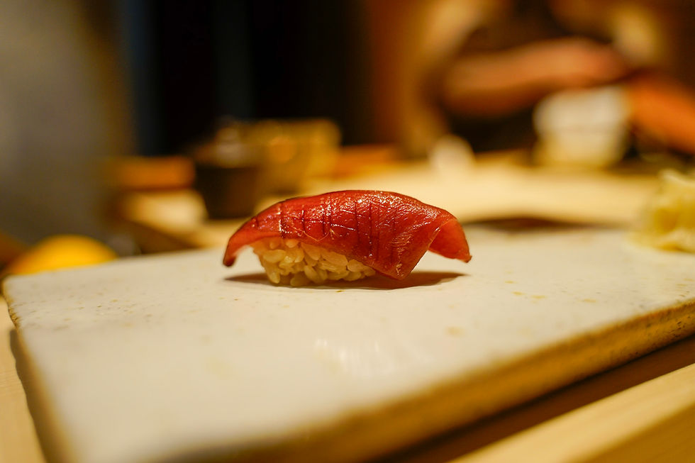Eye-level view of a beautifully arranged sushi platter showcasing seasonal fish and garnishes