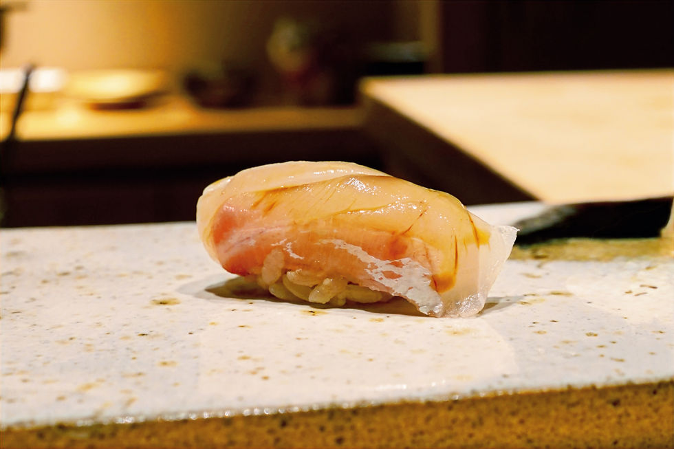 Close-up view of a perfectly crafted nigiri sushi piece