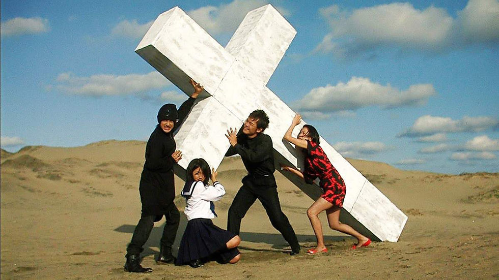 Four characters carrying a giant crucifix in the movie Love Exposure by Sion Sono.
