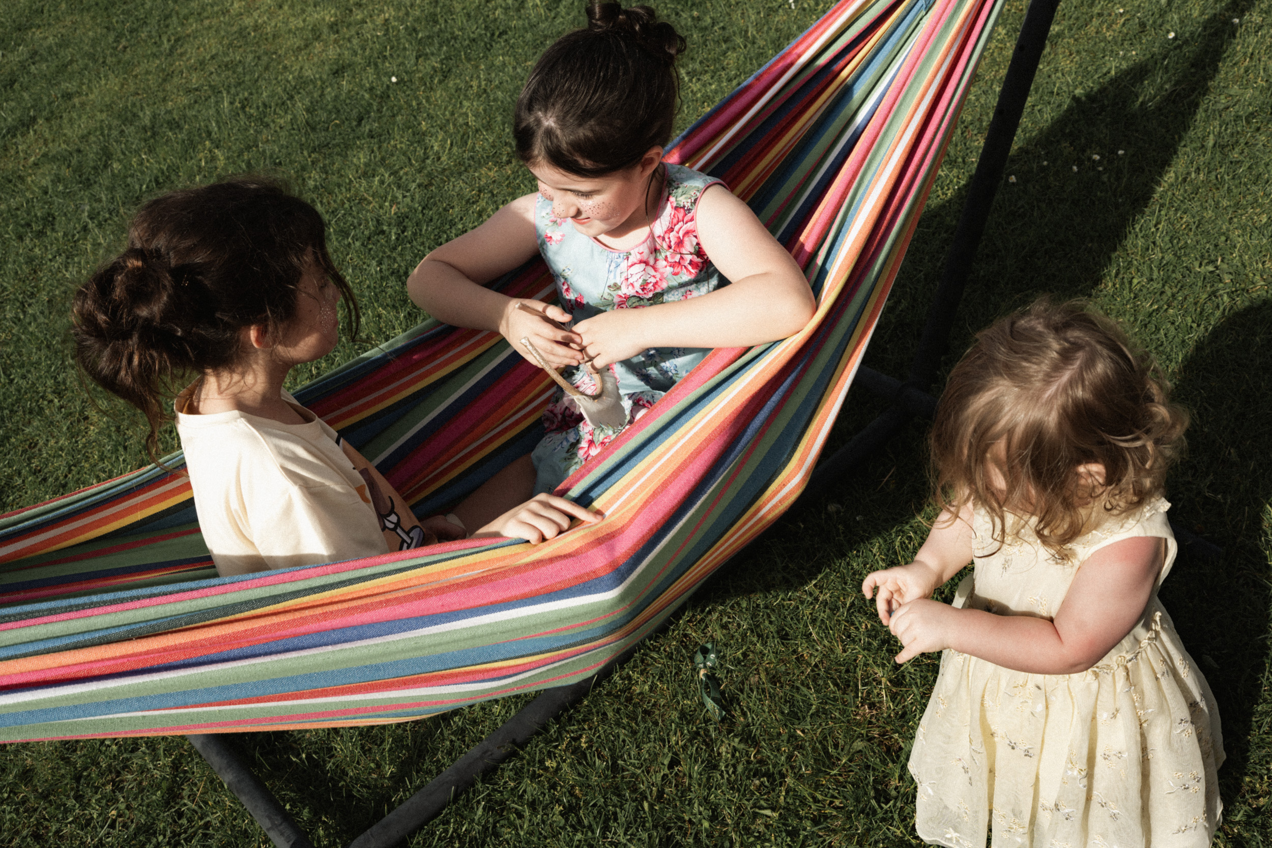 Documentary wedding photograph of children playing in a hammock
