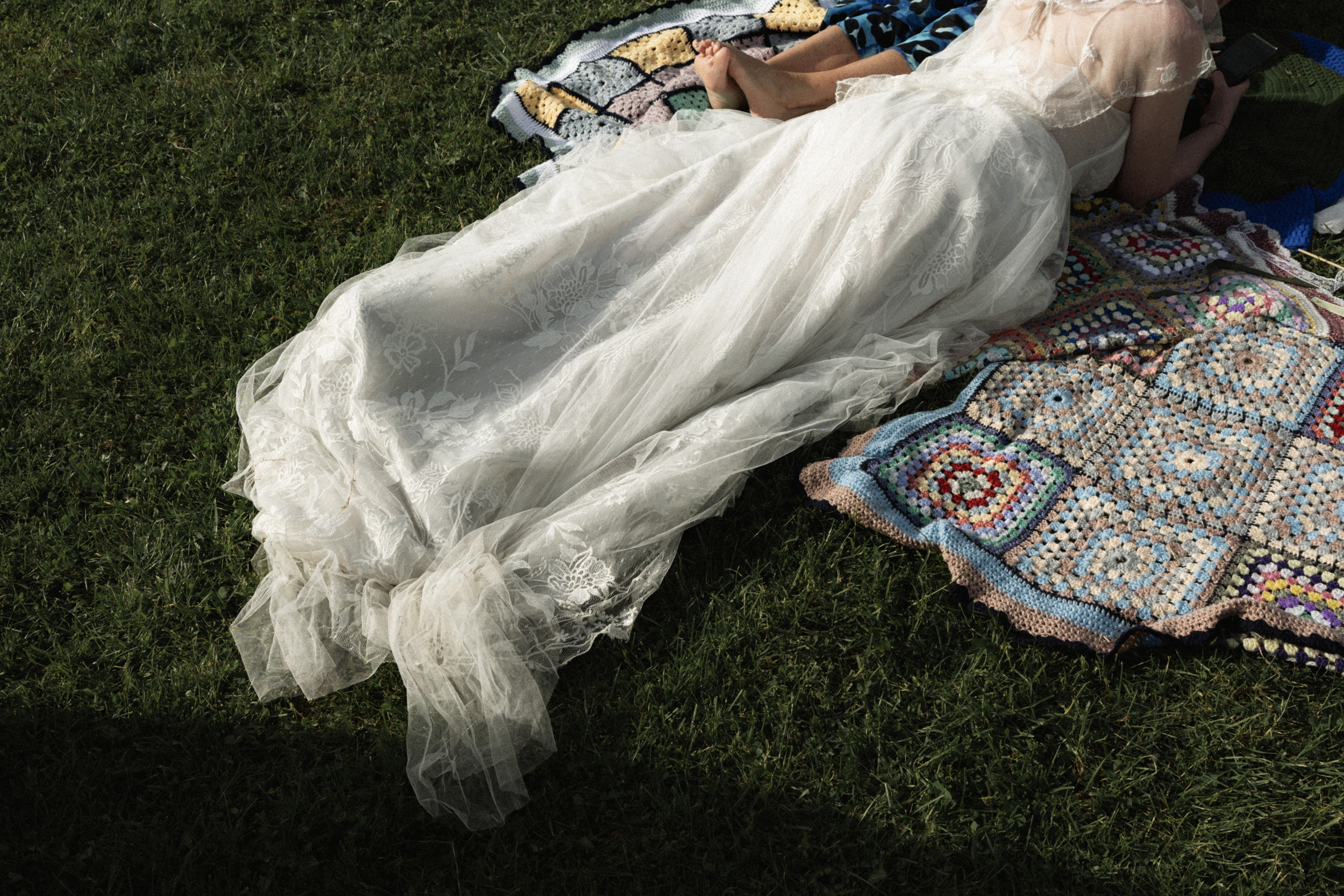 Bride laying on the blanket after the wedding ceremony