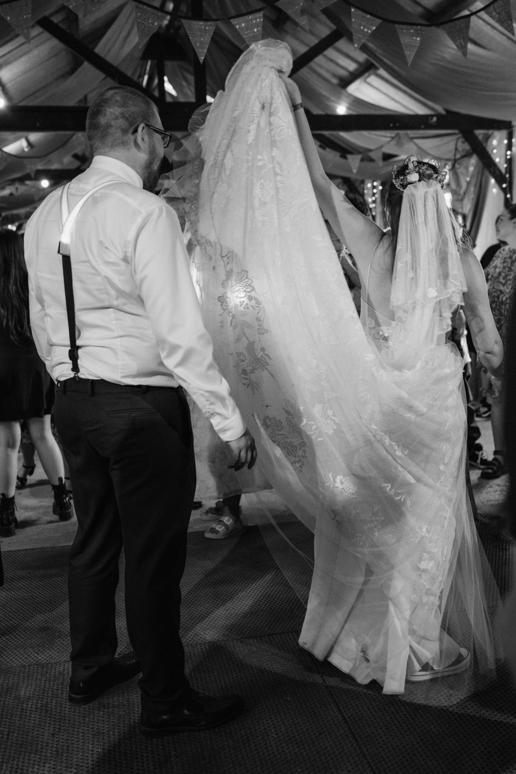 Bride lifting her dress on the dance floor