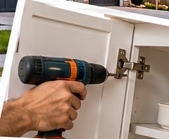 Adjusting a cabinet hinge with a drill