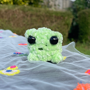 Chenille frog on table in back garden
