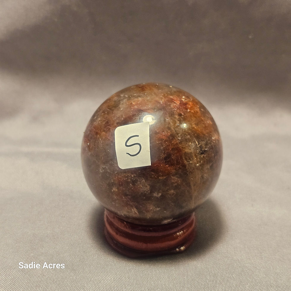 Hand-selected Yopalite gemstone sphere on a wooden stand.