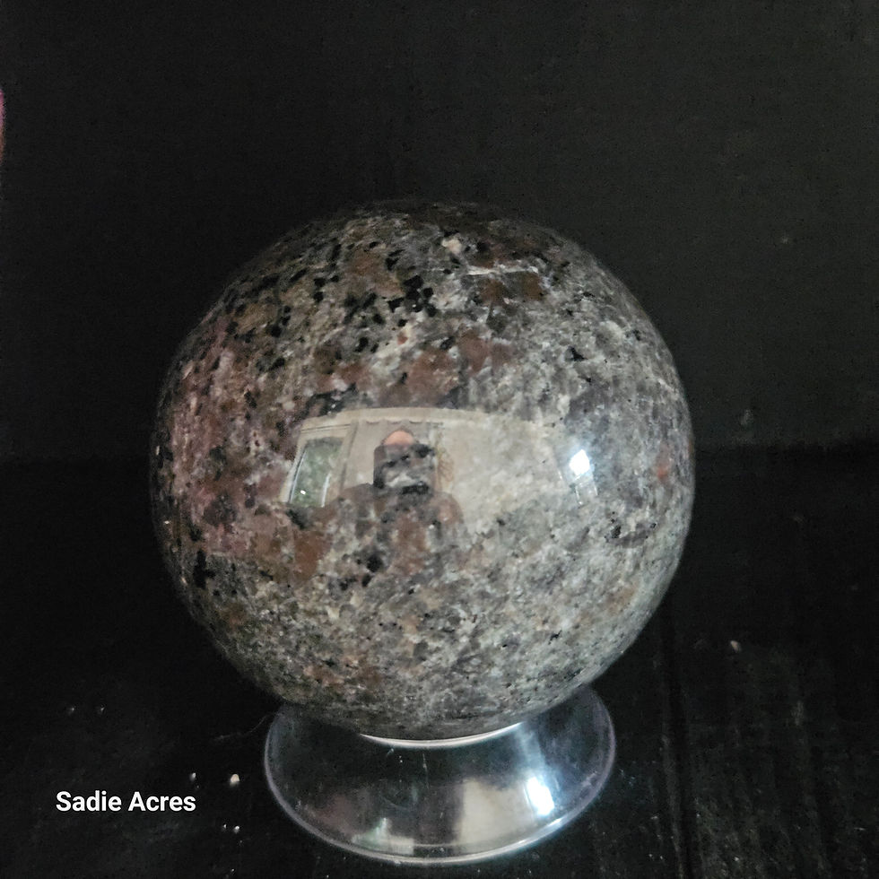 Hand-selected crystal sphere on a stand by Sadie Acres.