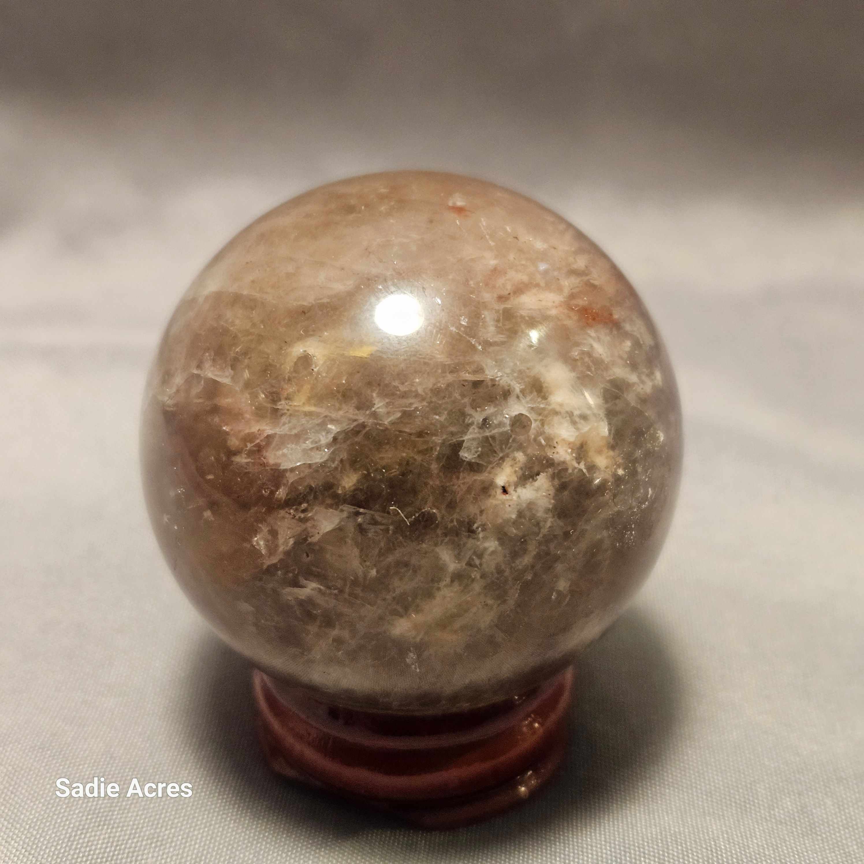 Hand-selected Yopalite gemstone crystal sphere on a stand.
