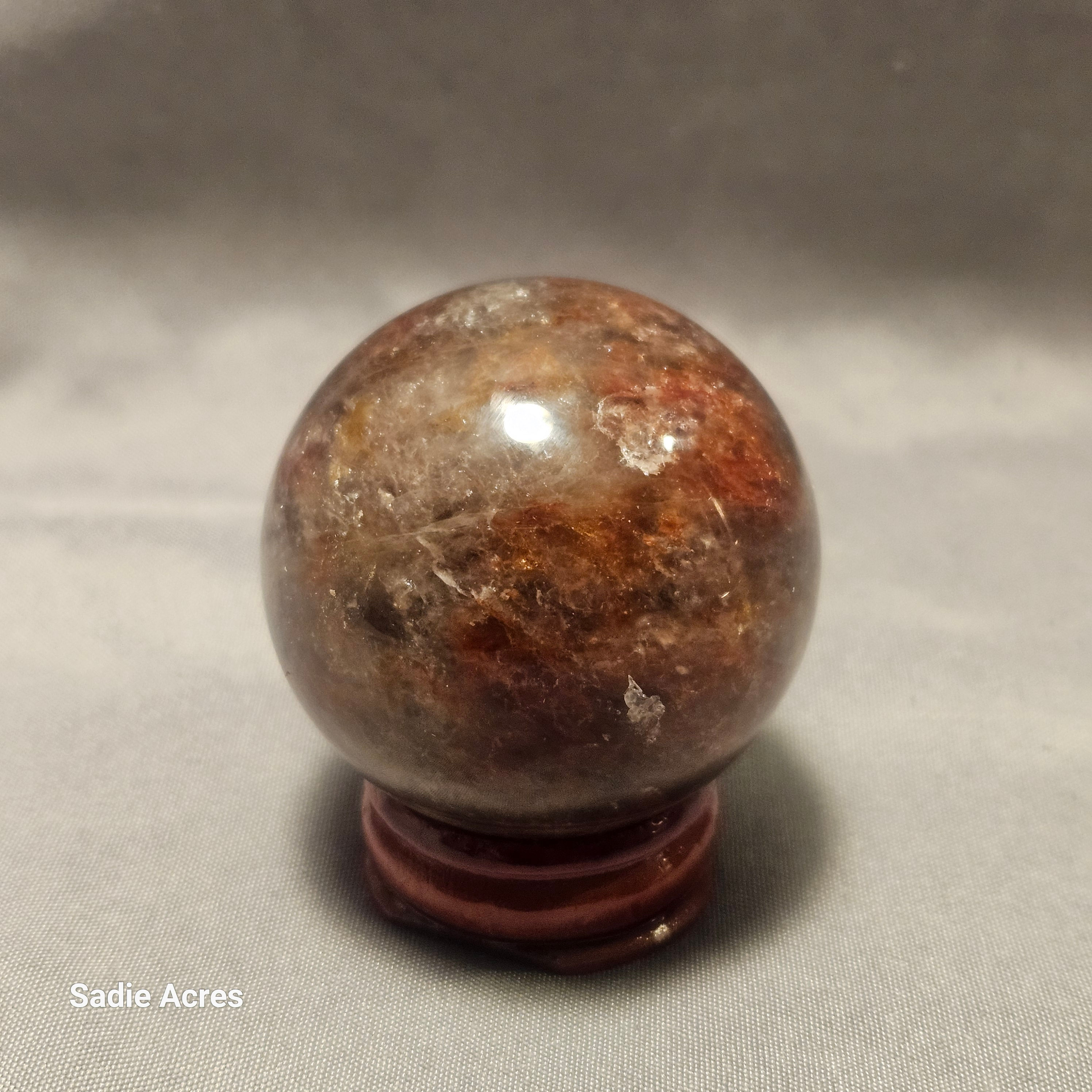 Hand-selected Yopalite gemstone crystal sphere on a stand.
