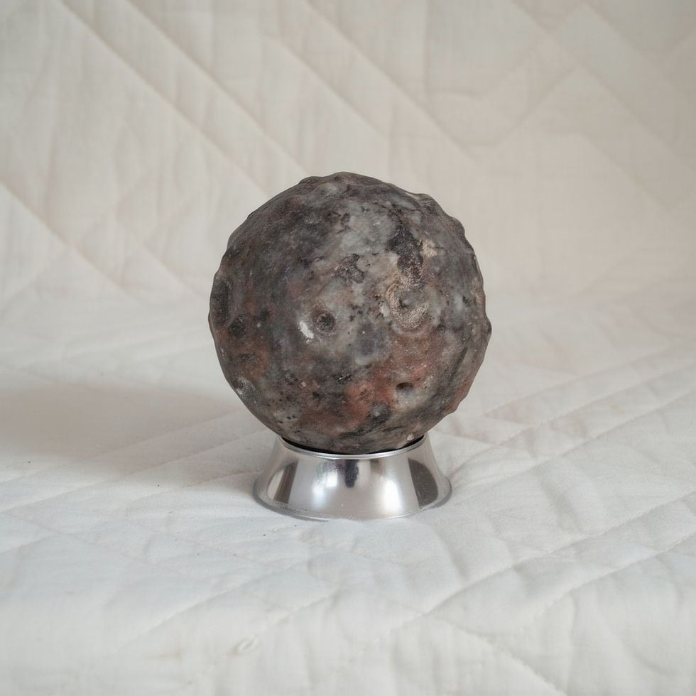 Hand-selected crystal sphere on a silver artisan stand.