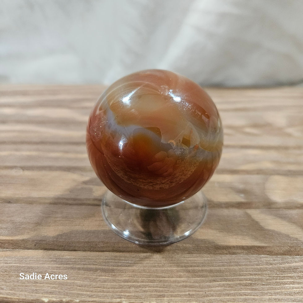 Artisan banded gemstone crystal sphere on a clear stand