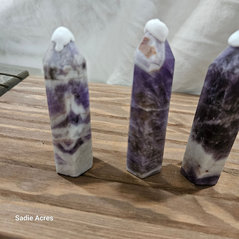 Three hand-selected gemstone points on a wood surface.