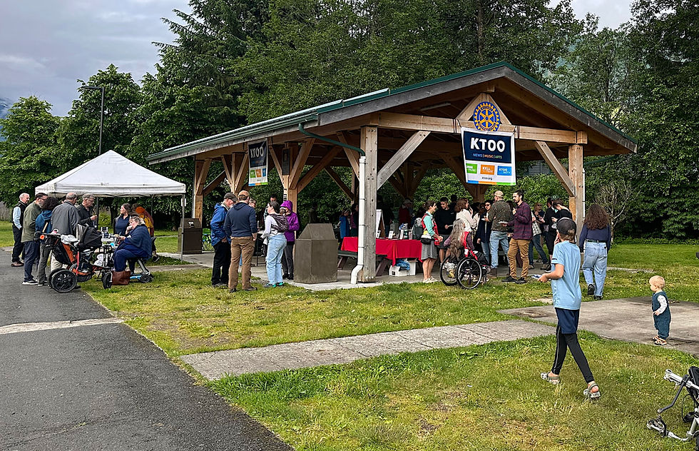 People gather at a KTOO community barbecue at Riverside Rotary Park on Thursday, July 17, 2025. Emergency response officials provided information and materials related to glacier outburst floods, with weather forecasters predicting such a flood from Suicide Basin is likely within a few weeks. (Mark Sabbatini / Juneau Independent)