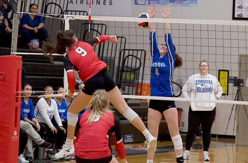Juneau-Douglas High School: Yadaa.at Kalé’s Ruby Koski (9) spikes a ball past Cordova High School’s Layla Phillips during the Crimson Bears’ Gold Bracket victory in the 2026 Juneau Volleyball Extravaganza tournament on Saturday, Oct. 3, 2026, at the George Houston Gymnasium. (Mark Sabbatini / Juneau Independent)