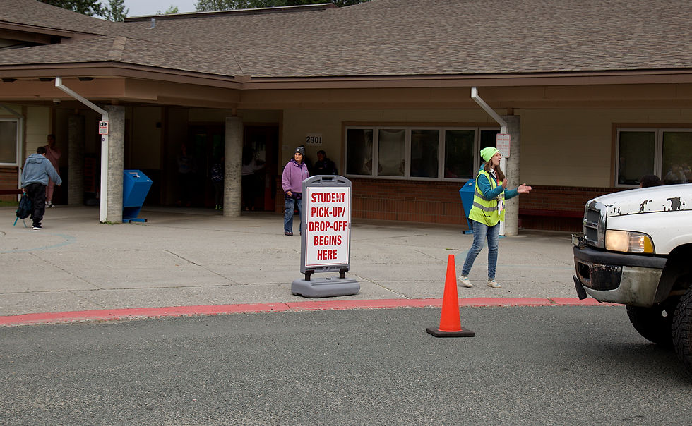 Rose Rice, a paraeducator at Kax̲dig̲oowu Héen Elementary School, greets people in an arriving vehicle on Thursday, Aug. 20, 2026. (Mark Sabbatini / Juneau Independent)