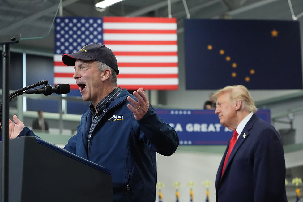 President Donald Trump listens as Sen. Dan Sullivan, R-Alaska, speaks at a campaign rally at the Curtis D. Menard Memorial Sports Center, Tuesday, Oct. 13, 2026, in Wasilla. (AP Photo/Alex Brandon)